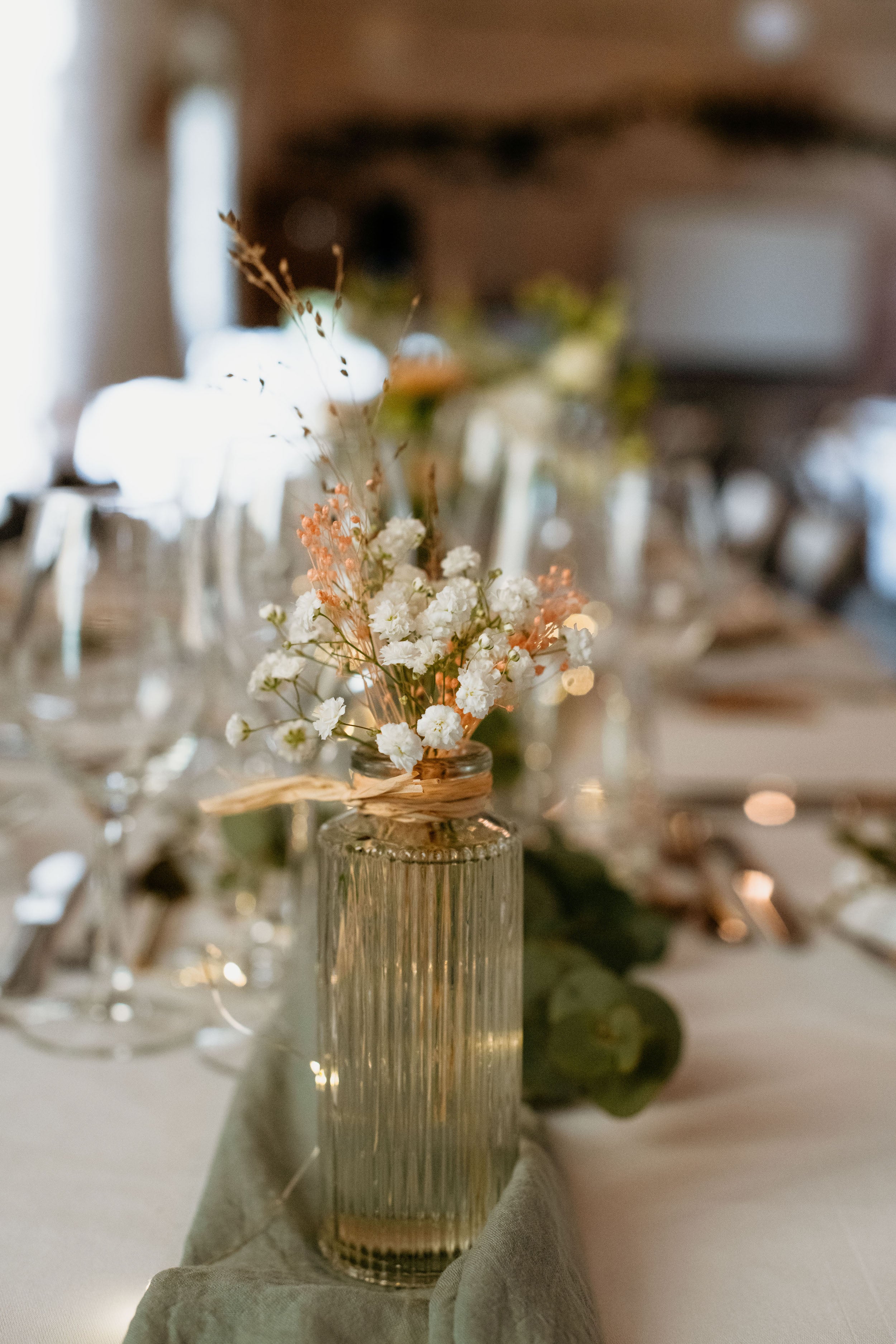 Focus sur un bouquet de fleur placé au centre des tables de la réception